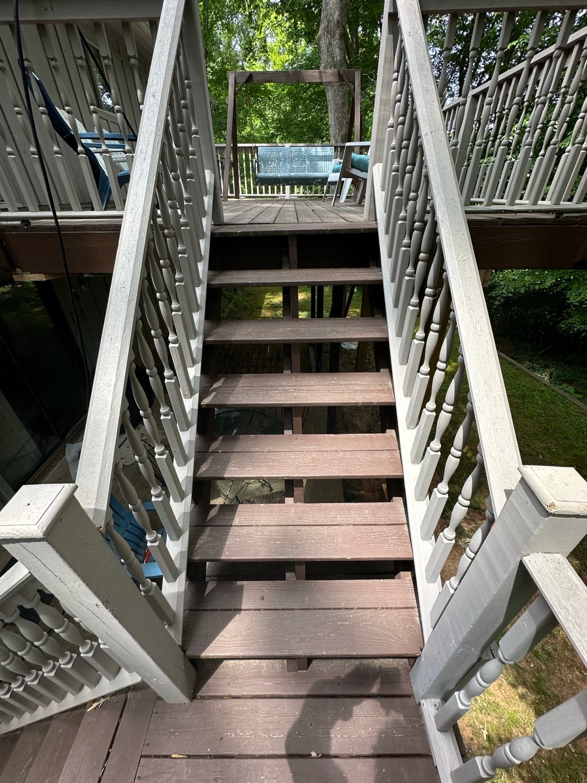 Deck stairs and railing before cleaning, dull and weathered